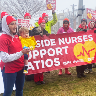 Maine nurses speaker at the presser with signs "Bedside nurses support ratios"
