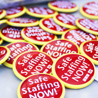 Pile of "Safe Staffing Now" buttons