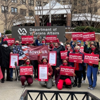 Nurses holding signs "Staff Up for Safe Patient Care"