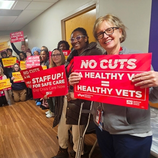 Nurses in hallway holding signs "No Cuts: A Healthy VA = Healthy Vets"