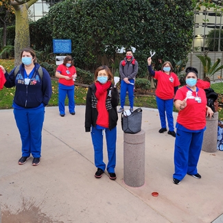 Group of nurses holding rally outside hospital 