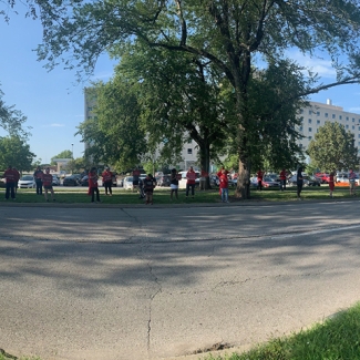 Wide shot of nurses protesting in front of hospital