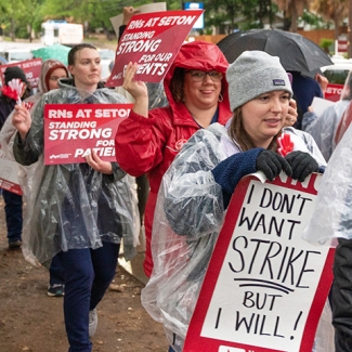 Nurses picketing in the rain