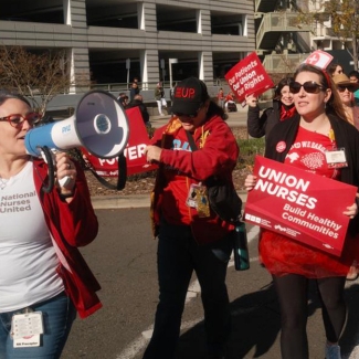 UC nurses rally holding signs