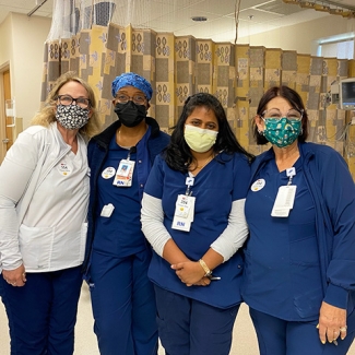Group of four nurses inside hospital