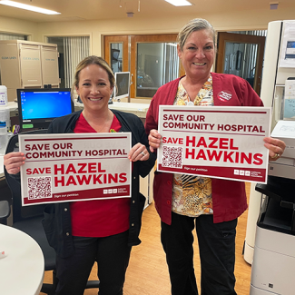 Nurses holding signs, "Save our community hospital, save Hazel Hawkins"