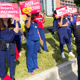 St. Agnes nurses holding signs "Our Union. Our Rights. Our Patients." "Safe Staffing saves lives" "Patients first in the hospital"
