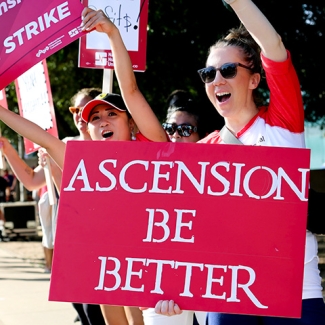 Nurse holding sign "Ascension: Be Better"