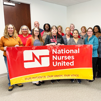 Tampa nurses holding banner "National Nurses United: Our Patients, Our Union, Our Voice"