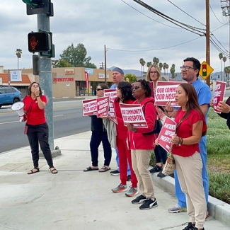Nurses rallying outside of Hemet Global Medical Center, holding signs "Our Community, Our Hospital"