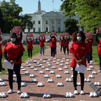 Nurses outside The White House holding signs calling for nurse, patient, and public safety