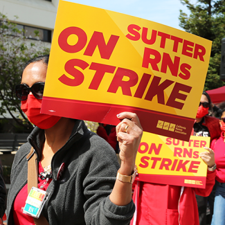 Nurses marching holding sign "Sutter RNs on strike"
