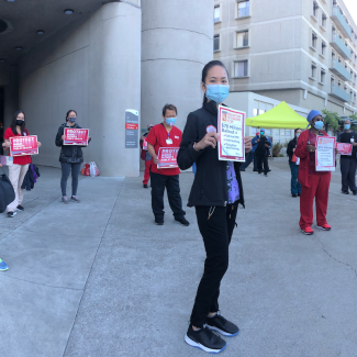 Nurse holds "Protect Nurses" signs