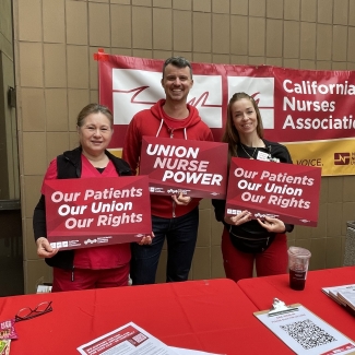 UCSD nurses hold signs in support of union rights and patient safety.
