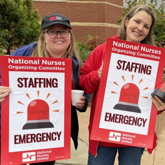 Asheville nurses hold signs that read "Staffing Emergency"
