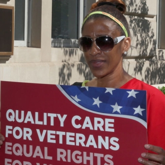 RN holding sign