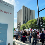 Nurses on sidewalks in front of Saint Mary of Nazareth Hospital emergency