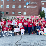 Cental Maine Medical Center nurses raising fists and holding signs "Prime RNs united for our patients."