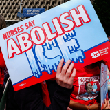 Hand holding signs "Nurses Say Abolish ICE"