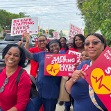 Nurses outside holding signs "Safe Staffing Saves Lives"