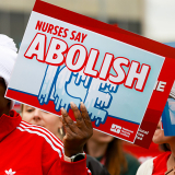 Hands holding signs "ICE not welcome here" and "Abolish ICE"