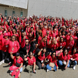 Large group of nurses with raised fists
