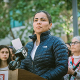 Dr. Aisha Wahab outside, at podium