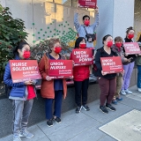 Nurses holding signs "Union Nurse Power"