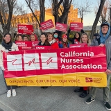 Group of 12 nurses holding banner "California Nurses Association"