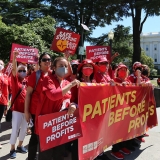 Nurses rally with signs that read "Patients over profits!"