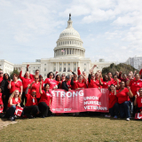 Large group of nurses outside capitol building, NNU logo