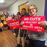 Nurses in hallway holding signs "No Cuts: A Healthy VA = Healthy Vets"
