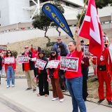 Nurses rallying in front of hospital, holding signs "No Cuts: A Healthy VA = Healthy Vets"