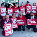 Alameda nurses in front of hospital with signs: "Some cuts don't heal" "Respect: Nurses, Our Patients, Our Community" "Patients before profits!"