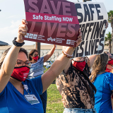 Corpus Christi nurses holding signs on street "Save lives: Safe staffing now" and "Safe staffing saves lives"