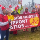 Maine nurses holding banner "Bedside nurses support ratios"