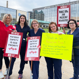 RNs outside Saint Louis University Hospital with signs "Patient safety is our priority" "NNOC RNs are patient advocates" "Patients are sick, nurses are tired..."