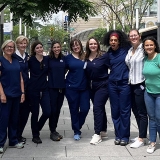 Group of nurses arm-in-arm outside
