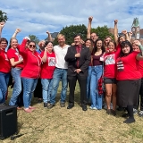 Nurses standing with Troy Jackson and Graham Platner, raised fists