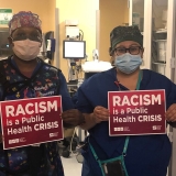 nurses holding signs