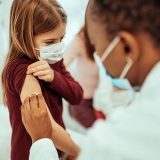 Nurse prepparing child for vaccine