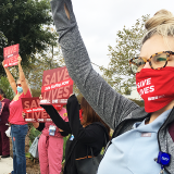 Members holding signs "Save lives: Safe staffing now"