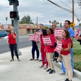 Nurses rallying outside of Hemet Global Medical Center, holding signs "Our Community, Our Hospital"