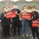 Nurses hold signs calling for safe staffing