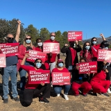 Group of nurses with raised fists