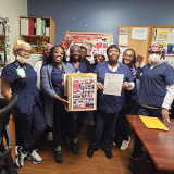 Nurses inside hospital holding letter