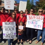 nurses holding signs in support of transgender youth
