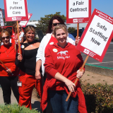 Nurses hold signs for safe staffing