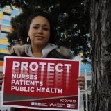 Nurse holding sign for more PPE