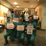 nurses holding signs